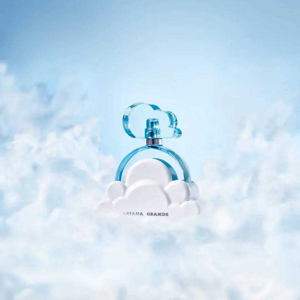 Perfume bottle with cloud design on a light blue background
