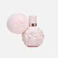 Pink perfume bottle with geometric design on a white background