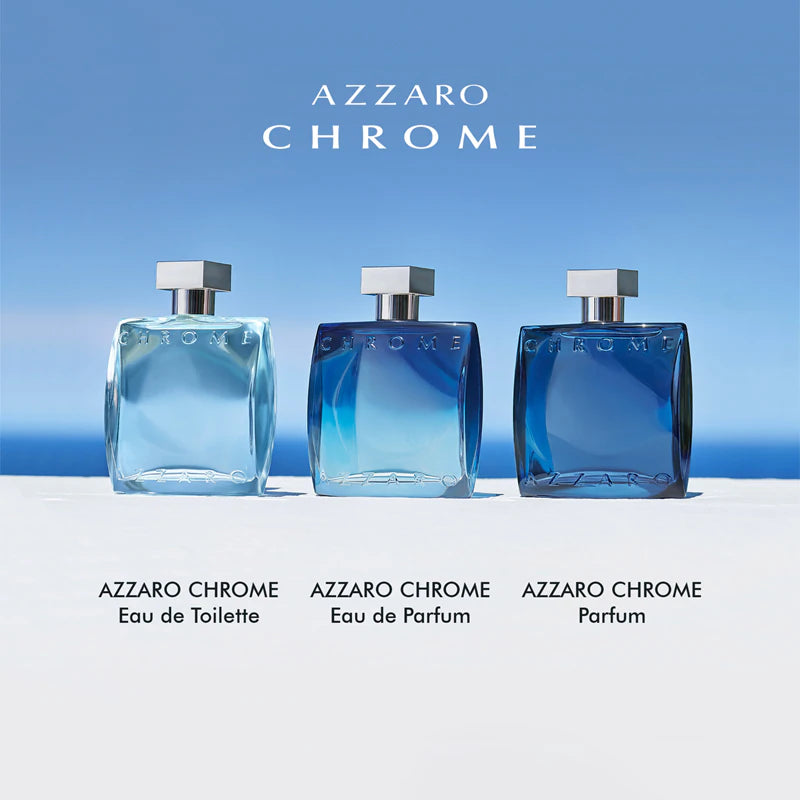 Three Azzaro Chrome perfume bottles on a white surface with a blue sky background