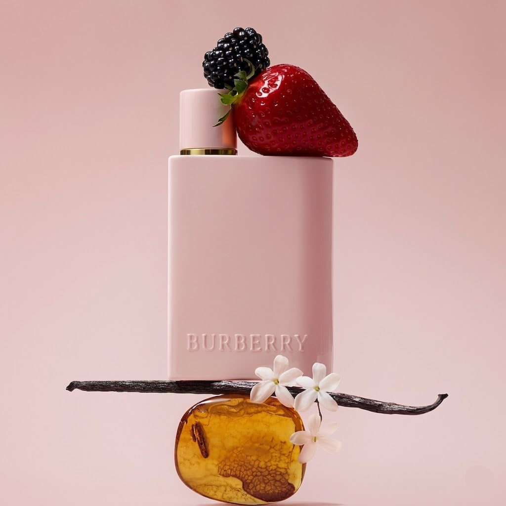 Burberry perfume bottle with strawberry, blackberry, vanilla bean, and flowers on a pink background