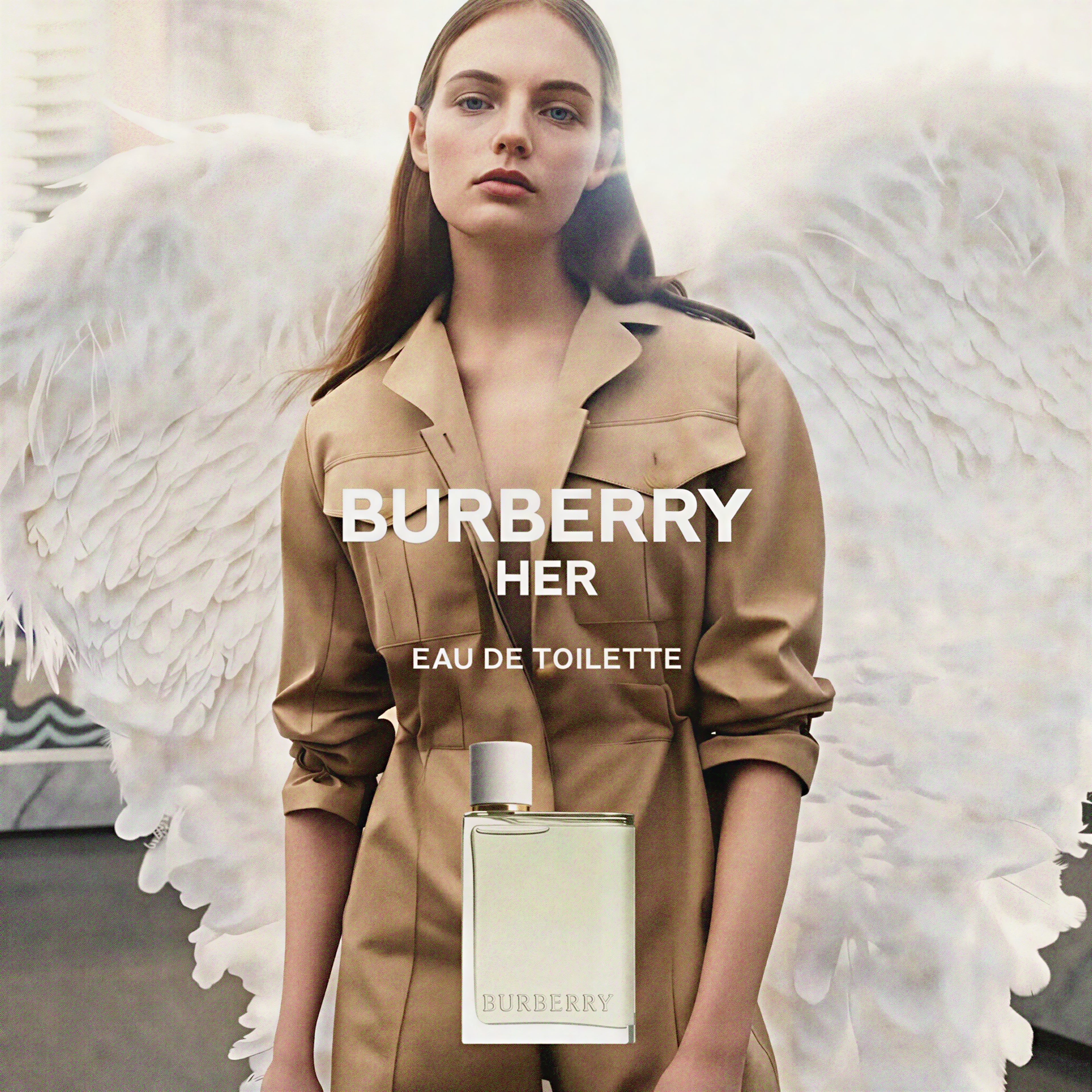 Burberry Her Eau de Toilette with a model wearing a beige trench coat against a white background.